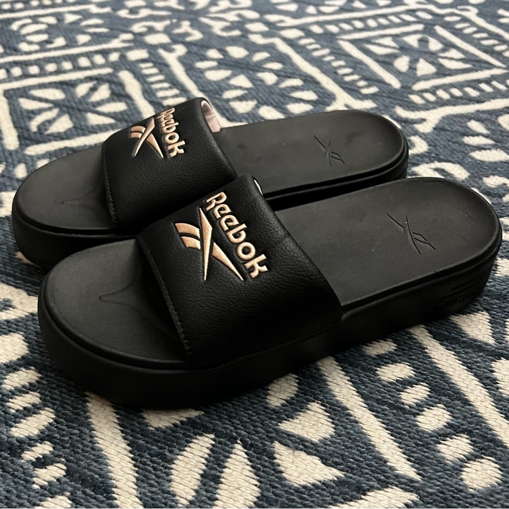 NWOT Ladies Reebok Black Slides With Rose Gold Logo. Size 8 Sandals